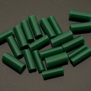 May include: A group of green wax sticks, likely for jewelry making or crafting.