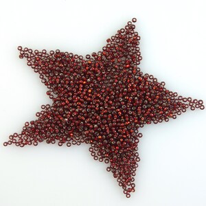 May include: A red star shape made from small, round beads.