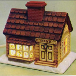 May include: A ceramic toy store building with a brown roof and a lit window displaying toys. The building has a sign that reads "TOYS".
