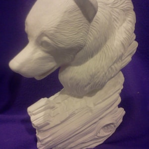 May include: White ceramic bear head sculpture with detailed fur texture, perched on a textured log base.