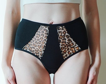 Embrace style and comfort with our chic black cotton panties, featuring leopard print accents and mesh insets. All sizes.