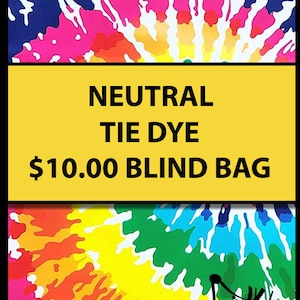 May include: A yellow and black sign with the text "NEUTRAL TIE DYE $10.00 BLIND BAG" on a background of a colorful tie-dye pattern. The sign is from the shop "Curious Minds Busy Bags".