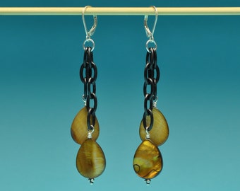 May include: A pair of dangle earrings with black chain links and two teardrop-shaped iridescent brown shell beads.