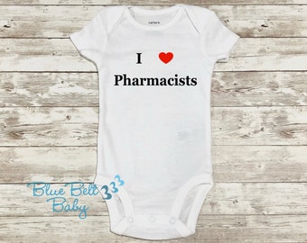 May include: White baby onesie with a red heart and the text "I love Pharmacists".