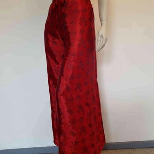Beautiful red figured silk pants custom made in Hoi An, Vietnam. In the style of fishermen's pants, they tie at the waist, are passed between the legs and tie at the waist again. Wide legged, the sides are over lapped and not fastened.  Medium.