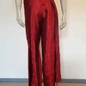 Beautiful red figured silk pants custom made in Hoi An, Vietnam. In the style of fishermen's pants, they tie at the waist, are passed between the legs and tie at the waist again. Wide legged, the sides are over lapped and not fastened.  Medium.