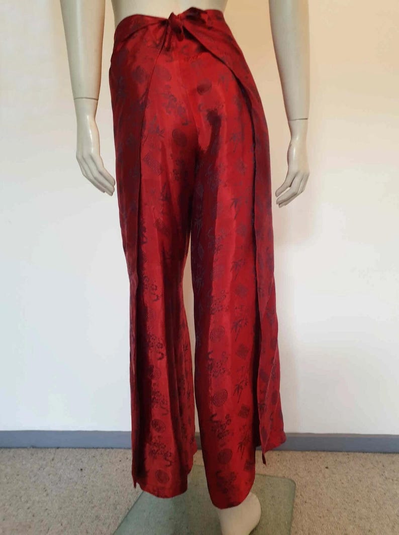 Beautiful red figured silk pants custom made in Hoi An, Vietnam. In the style of fishermen's pants, they tie at the waist, are passed between the legs and tie at the waist again. Wide legged, the sides are over lapped and not fastened.  Medium.