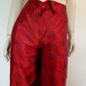 Beautiful red figured silk pants custom made in Hoi An, Vietnam. In the style of fishermen's pants, they tie at the waist, are passed between the legs and tie at the waist again. Wide legged, the sides are over lapped and not fastened.  Medium.