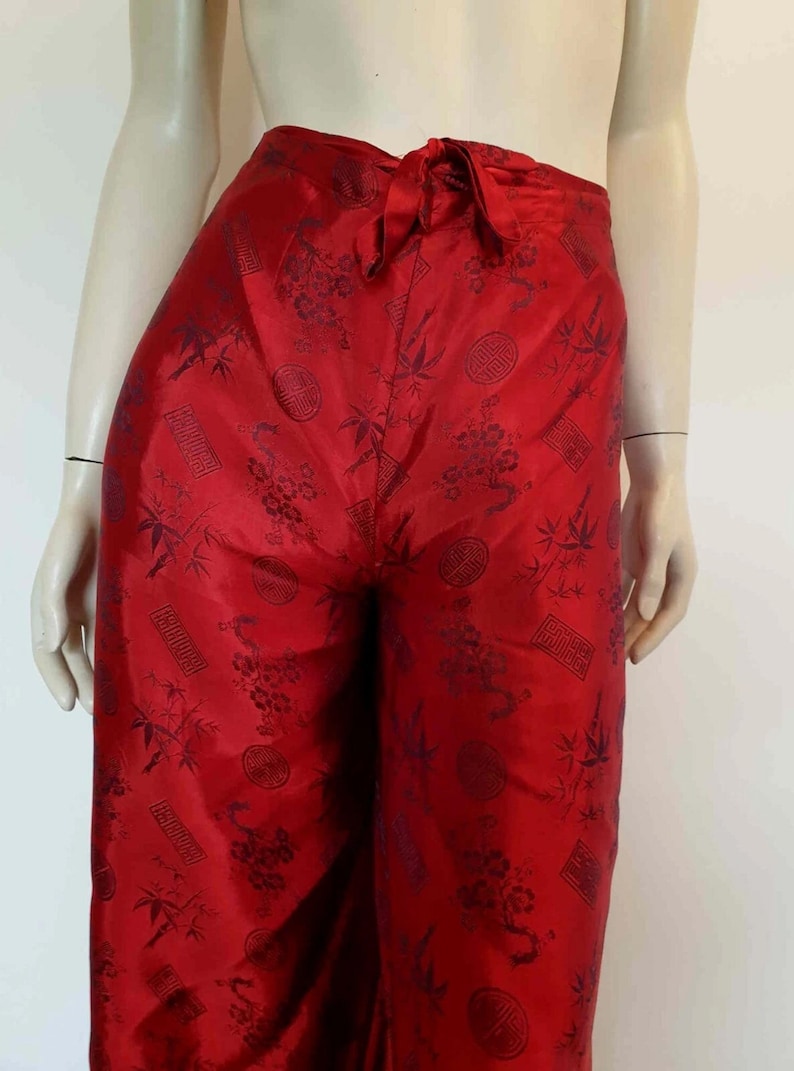 Beautiful red figured silk pants custom made in Hoi An, Vietnam. In the style of fishermen's pants, they tie at the waist, are passed between the legs and tie at the waist again. Wide legged, the sides are over lapped and not fastened.  Medium.