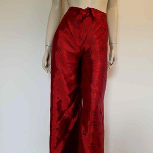 Beautiful red figured silk pants custom made in Hoi An, Vietnam. In the style of fishermen's pants, they tie at the waist, are passed between the legs and tie at the waist again. Wide legged, the sides are over lapped and not fastened.  Medium.
