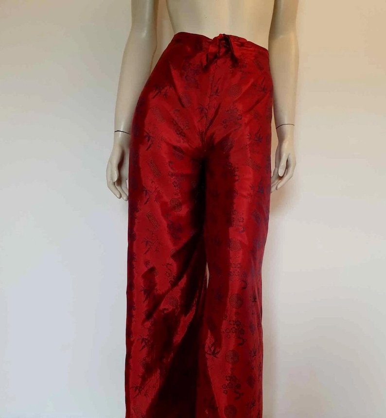 Beautiful red figured silk pants custom made in Hoi An, Vietnam. In the style of fishermen's pants, they tie at the waist, are passed between the legs and tie at the waist again. Wide legged, the sides are over lapped and not fastened.  Medium.