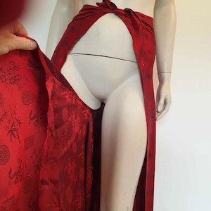 Beautiful red figured silk pants custom made in Hoi An, Vietnam. In the style of fishermen's pants, they tie at the waist, are passed between the legs and tie at the waist again. Wide legged, the sides are over lapped and not fastened.  Medium.