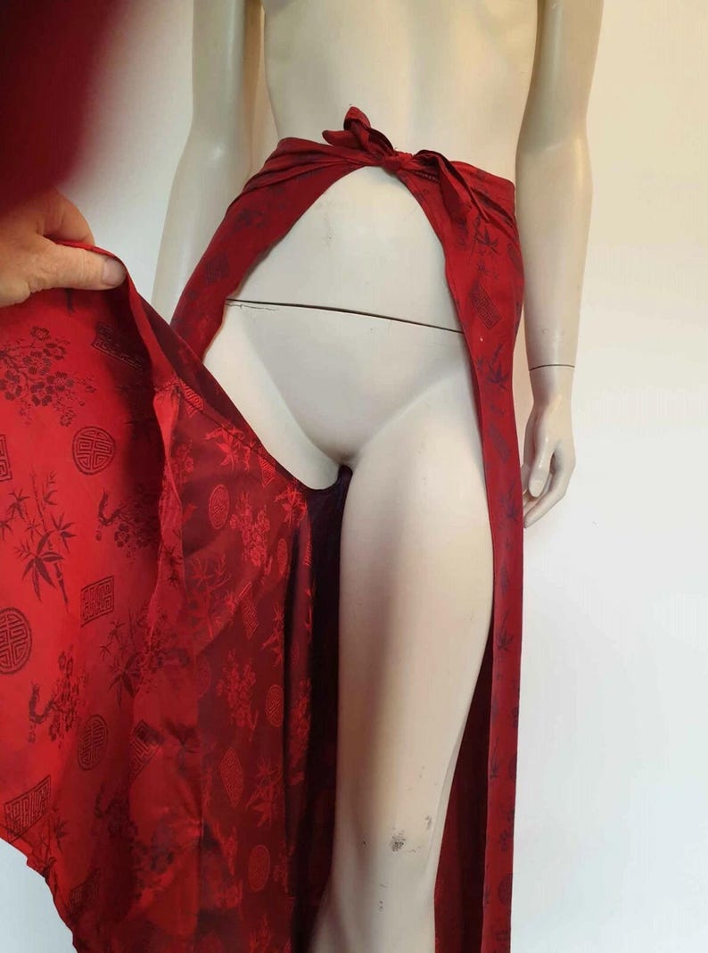 Beautiful red figured silk pants custom made in Hoi An, Vietnam. In the style of fishermen's pants, they tie at the waist, are passed between the legs and tie at the waist again. Wide legged, the sides are over lapped and not fastened.  Medium.
