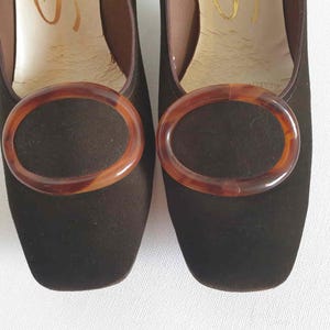 Vintage Vintage Chocolate brown suede pumps have squared off toes and large faux tortoiseshell (plastic) buckle trim. Mid height heels. Leather half lining, insoles and soles. Brand is Siranna by Westbrook - 1960s. Size Au/US 6C