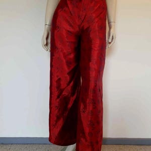 Beautiful red figured silk pants custom made in Hoi An, Vietnam. In the style of fishermen's pants, they tie at the waist, are passed between the legs and tie at the waist again. Wide legged, the sides are over lapped and not fastened.  Medium.