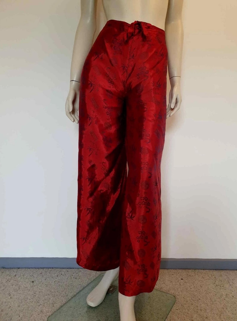 Beautiful red figured silk pants custom made in Hoi An, Vietnam. In the style of fishermen's pants, they tie at the waist, are passed between the legs and tie at the waist again. Wide legged, the sides are over lapped and not fastened.  Medium.