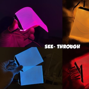 Peut inclure: Un collage de panneaux lumineux et transparents en rose, orange, bleu et rouge. Les panneaux rectangulaires ont une surface texturée et sont éclairés de l'intérieur, avec le texte "SEE-THROUGH".