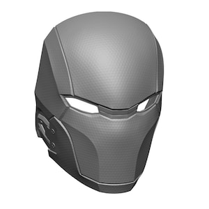 May include: A gray 3D printed helmet with a textured surface and a visor. The helmet has a futuristic design with sharp angles and a sleek profile.
