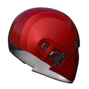 May include: A red helmet with a textured surface and black accents. The helmet has a visor and a chin strap.