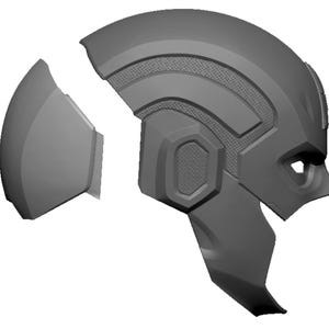 May include: A gray, segmented helmet, possibly for cosplay or a costume. The helmet is in multiple pieces, with detailed panels and textures. The design suggests a futuristic or superhero theme.