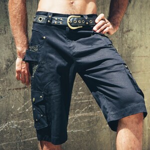 May include: Black cargo shorts with a leather belt and gold accents. The shorts have multiple pockets and a mesh panel on the side.