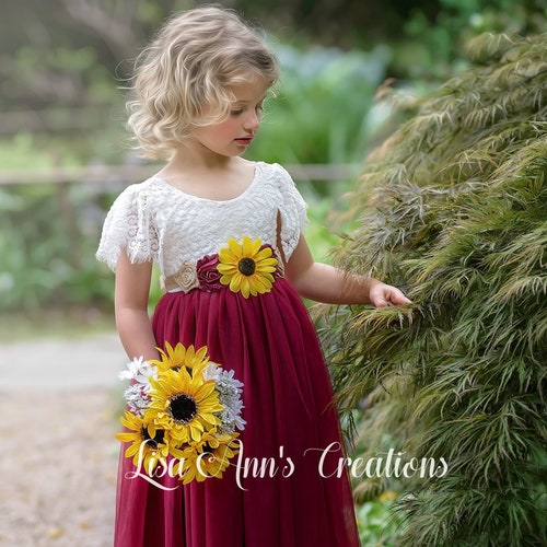red bridesmaid dresses with sunflowers Merlot dresses, sunflowers and red rose florals and smiles all around for  Keli & Kyle's Fall wedding at Saltwater Farm Vineyard. Whether it be a  statement color, flower or draping, we love