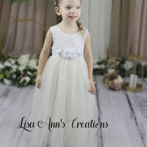 Lace flower girl dress in ivory with sleeveless and flowing tulle skirt