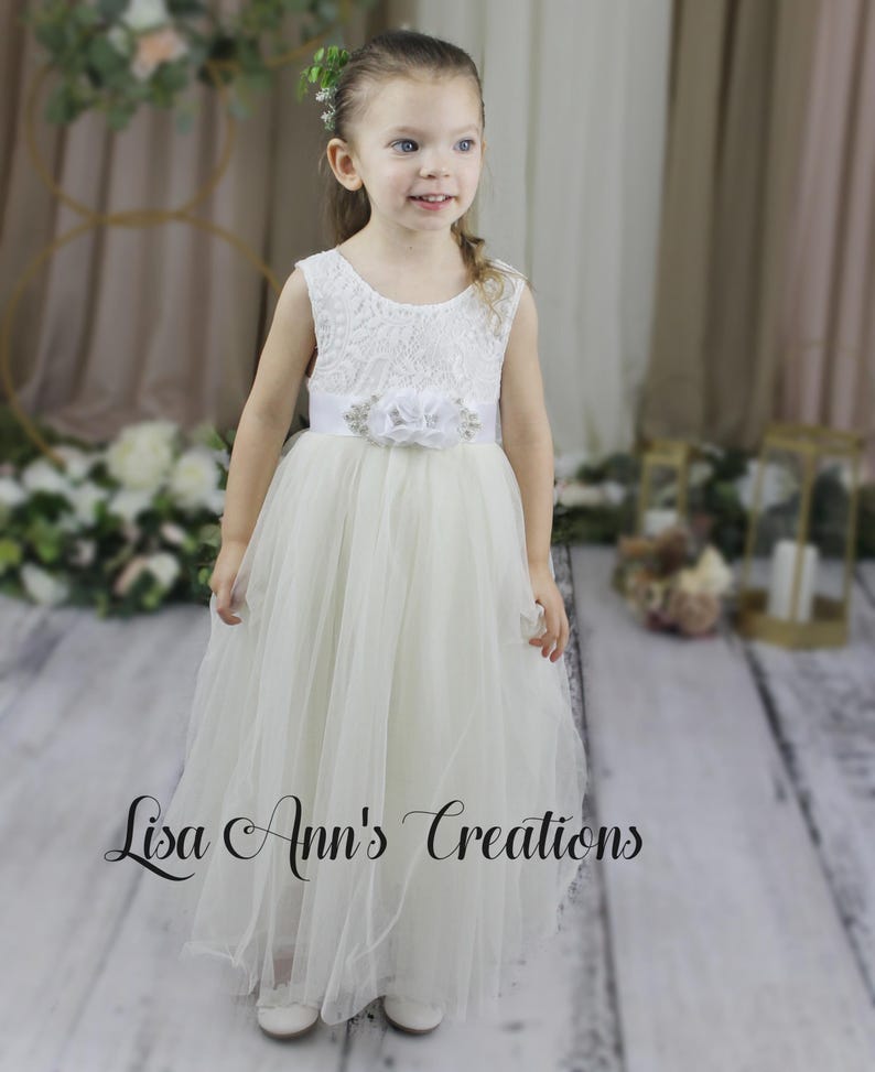 Lace flower girl dress in ivory with sleeveless and flowing tulle skirt