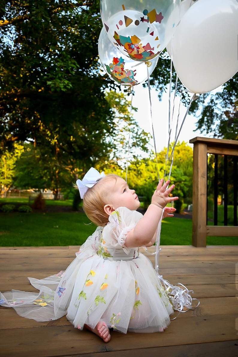 1st birthday white floral dress. A white dress with floral embroidery in short sleeve in tulle. built in romper.