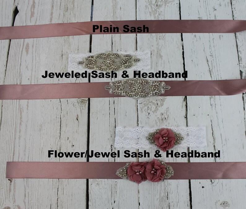 Sash choices for flower girl dress.  Three blush pink satin sashes with different embellishments. The top sash is plain. The middle sash has a jeweled sash and headband. The bottom sash has a flower jewel sash and headband.