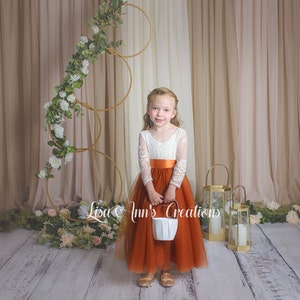Long sleeve burnt orange flower girl dress, full length tulle and white lace bodice.