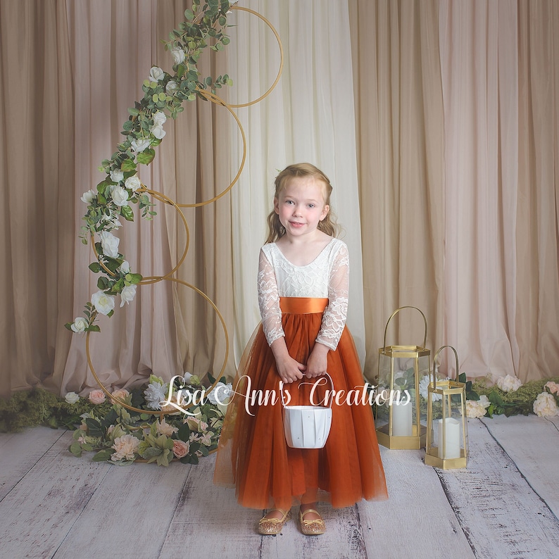 Long sleeve burnt orange flower girl dress, full length tulle and white lace bodice.
