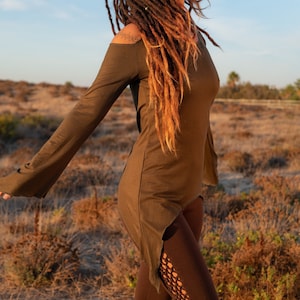 May include: A brown off-the-shoulder long-sleeved top with a high-low hemline. The top has a relaxed fit and flowing sleeves.