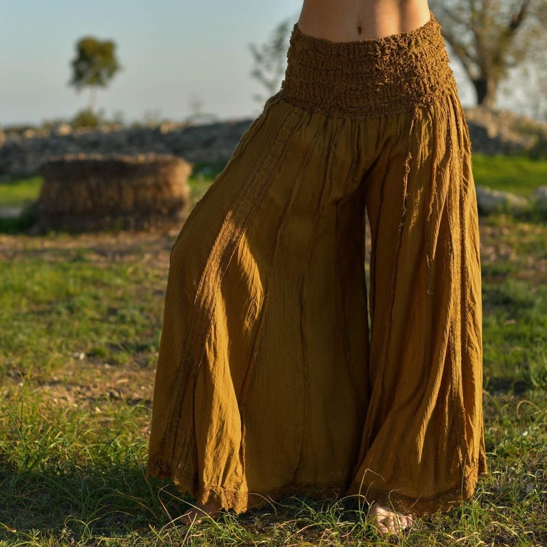 May include: Mustard yellow wide-leg pants with a gathered elastic waistband.