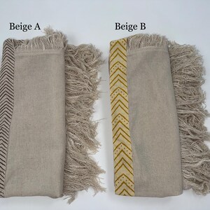 May include: Two beige textile items with fringed edges. One has a dark brown chevron pattern, the other has a yellow chevron pattern. The text "Beige A" and "Beige B" are visible.