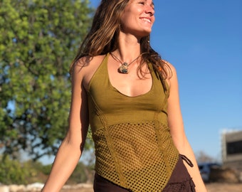 May include: A woman wearing a green halter top with a crocheted design and a brown skirt. She is smiling and looking up at the sky.