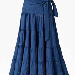May include: A tiered, floor-length blue skirt with a wrap-around tie at the waist. The skirt has a flowing silhouette and is made of a soft fabric. The word "Blue" is in the upper right corner. The brand name "kalbella" is visible.