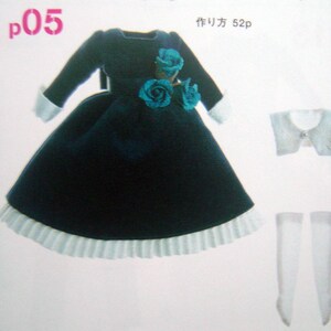 May include: A dark blue velvet dress with a white lace trim and a blue flower embellishment. The dress is accompanied by a white lace collar and white stockings.