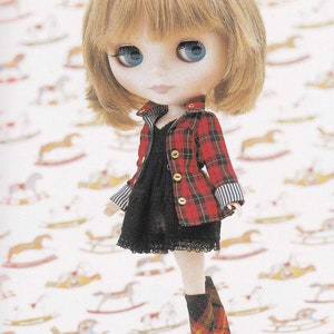 May include: A doll with blonde hair wearing a red and black plaid jacket over a black dress with lace trim. The doll is wearing white tights and red and black plaid socks with black shoes.