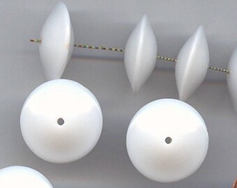 May include: Ten white plastic beads with a hole in the center. The beads are about the size of a US penny.
