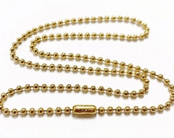 May include: A gold ball chain necklace with a small tag that reads "Chain".