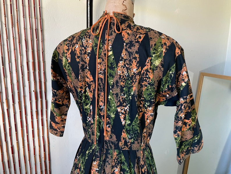 1950s Cotton Batik Day Dress by Barbette 34 Sleeve Pleated Full Skirt Orange Green and Black Mid Century Stepford New Look