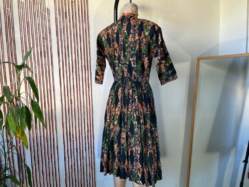1950s Cotton Batik Day Dress by Barbette 34 Sleeve Pleated Full Skirt Orange Green and Black Mid Century Stepford New Look