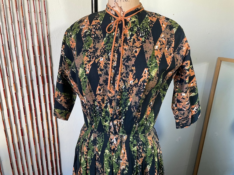 1950s Cotton Batik Day Dress by Barbette 34 Sleeve Pleated Full Skirt Orange Green and Black Mid Century Stepford New Look