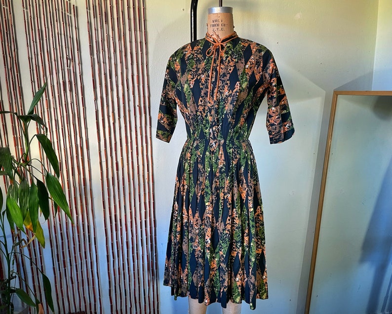 1950s Cotton Batik Day Dress by Barbette 34 Sleeve Pleated Full Skirt Orange Green and Black Mid Century Stepford New Look
