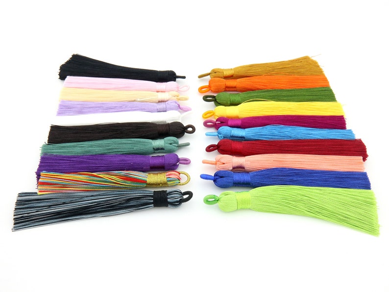 May include: Assortment of 18 colorful silk tassels with a variety of colors including black, white, pink, purple, green, blue, red, orange, and yellow.