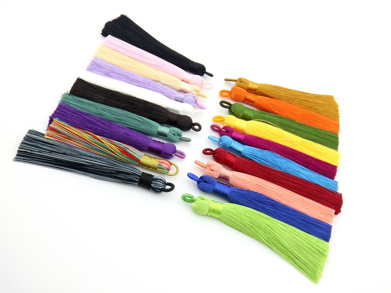 May include: Assortment of 16 colorful silk tassels with a variety of colors including black, pink, beige, purple, white, green, purple, grey, yellow, orange, blue, red, and light pink.