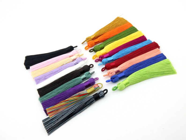 May include: Assortment of 15 colorful silk tassels with various lengths. The tassels are made of soft, silky material and have a variety of colors, including black, white, pink, purple, green, blue, red, yellow, and orange.