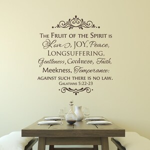 May include: A brown wall decal with a decorative flourish and the text "THE FRUIT OF THE SPIRIT IS Love, JOY, Peace, LONGSUFFERING, Gentleness, Goodness, Faith, Meekness, Temperance: AGAINST SUCH THERE IS NO LAW. GALATIANS 5:22-23"