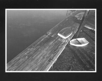 Black and white of dinghys on dock - photo card